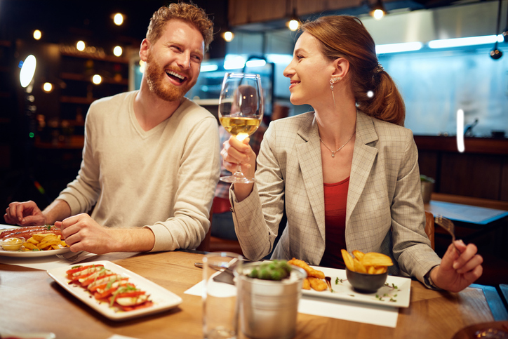 Smiling cheerful couple sitting in a restaurant