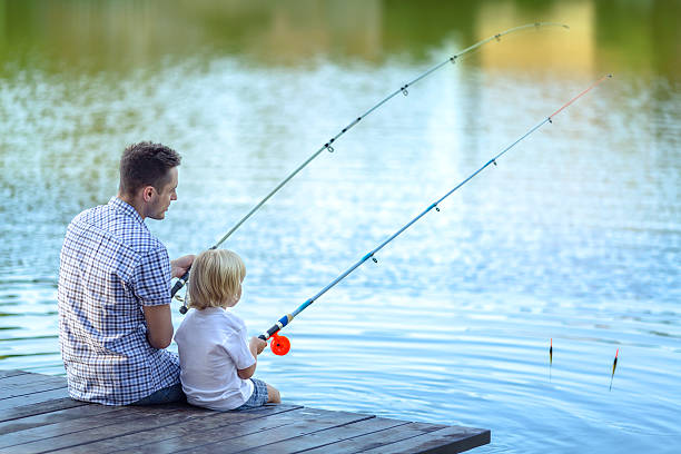 Dad and son fishing at lake