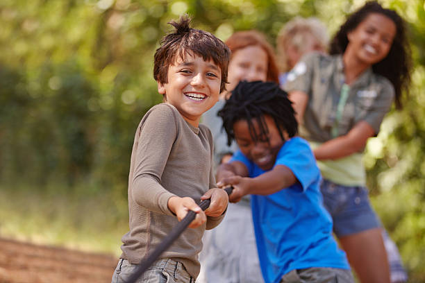 A group of kids in a tug-of-war game