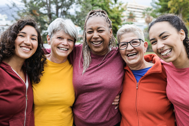 Happy multi generational women having fun together - Multiracial friends smiling on camera after sport workout outdoor - Main focus on african female face