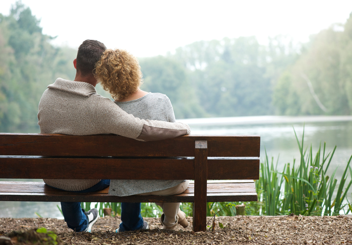 Rear view of a happy couple sitting 