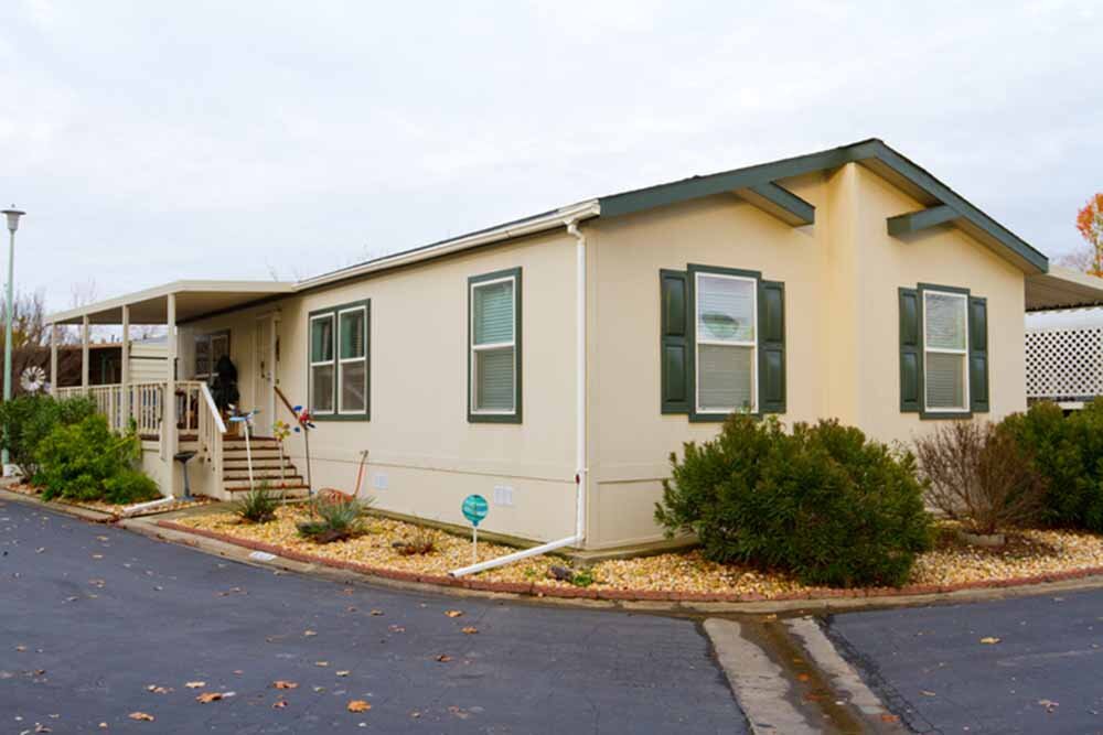 One story manufactured house with gravel and driveway