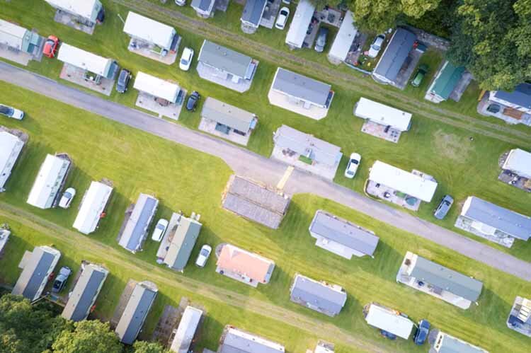 Caravan site park aerial view illuminated by summer sun