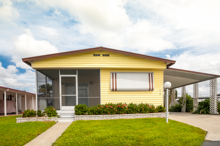 Static Caravan with front lawn and flowers.