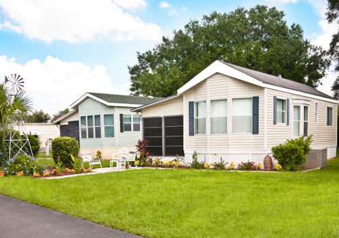 Mobile homes in a manufactured home park. Front yard.