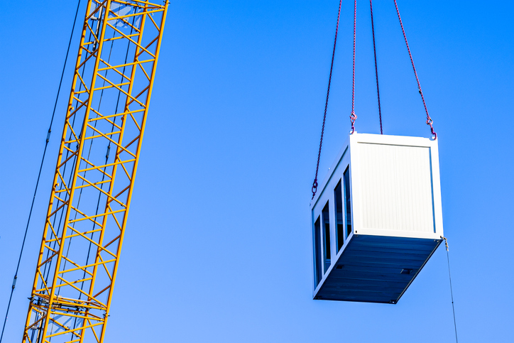 mobile office at a crane in front of blue sky