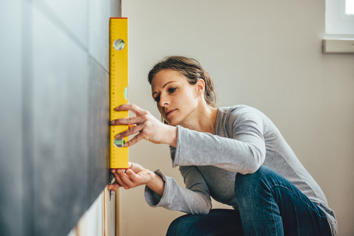 Woman using leveling tool