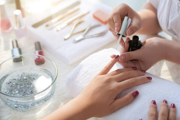 Close-up image of woman having her nails done in beauty salon