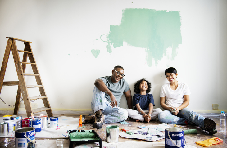 Black family painting house wall